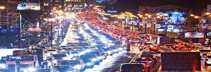 cars in dark traffic jam at night with lights on